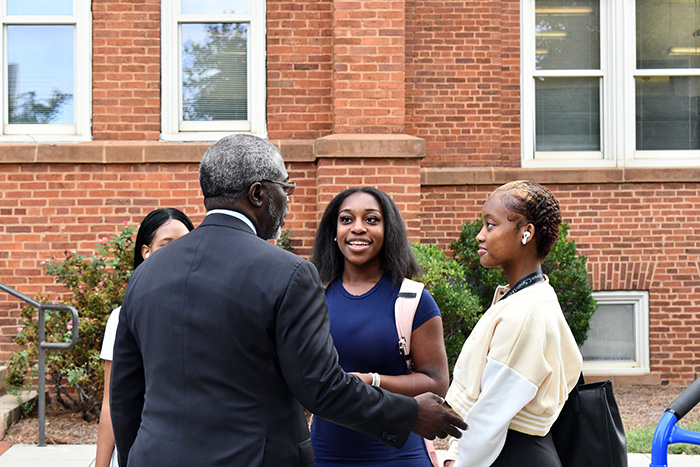 President Armbrister talking to students outside of Biddle Hall
