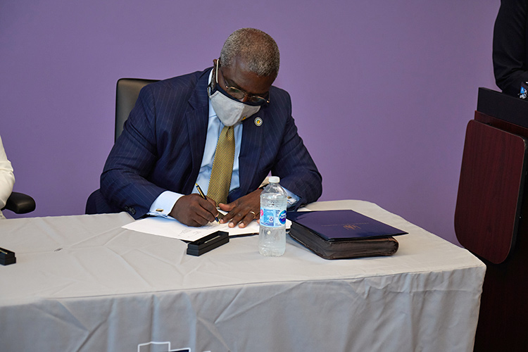 President Armbrister signing the 2+2 Connect program 