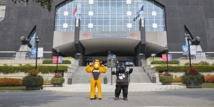 Photo of Smitty and Sir Purr in front of Bank of America Stadium