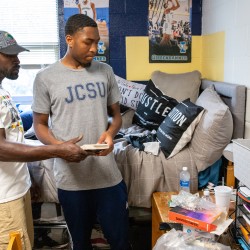 Student and parent decorate dorm room