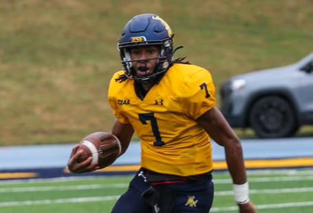 Golden Bull football player running with the ball