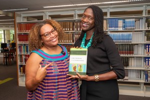 Dr. Valerie Kinloch, 皇冠体育's 15th president, poses with Dr. Terza Lima-Neves and her book