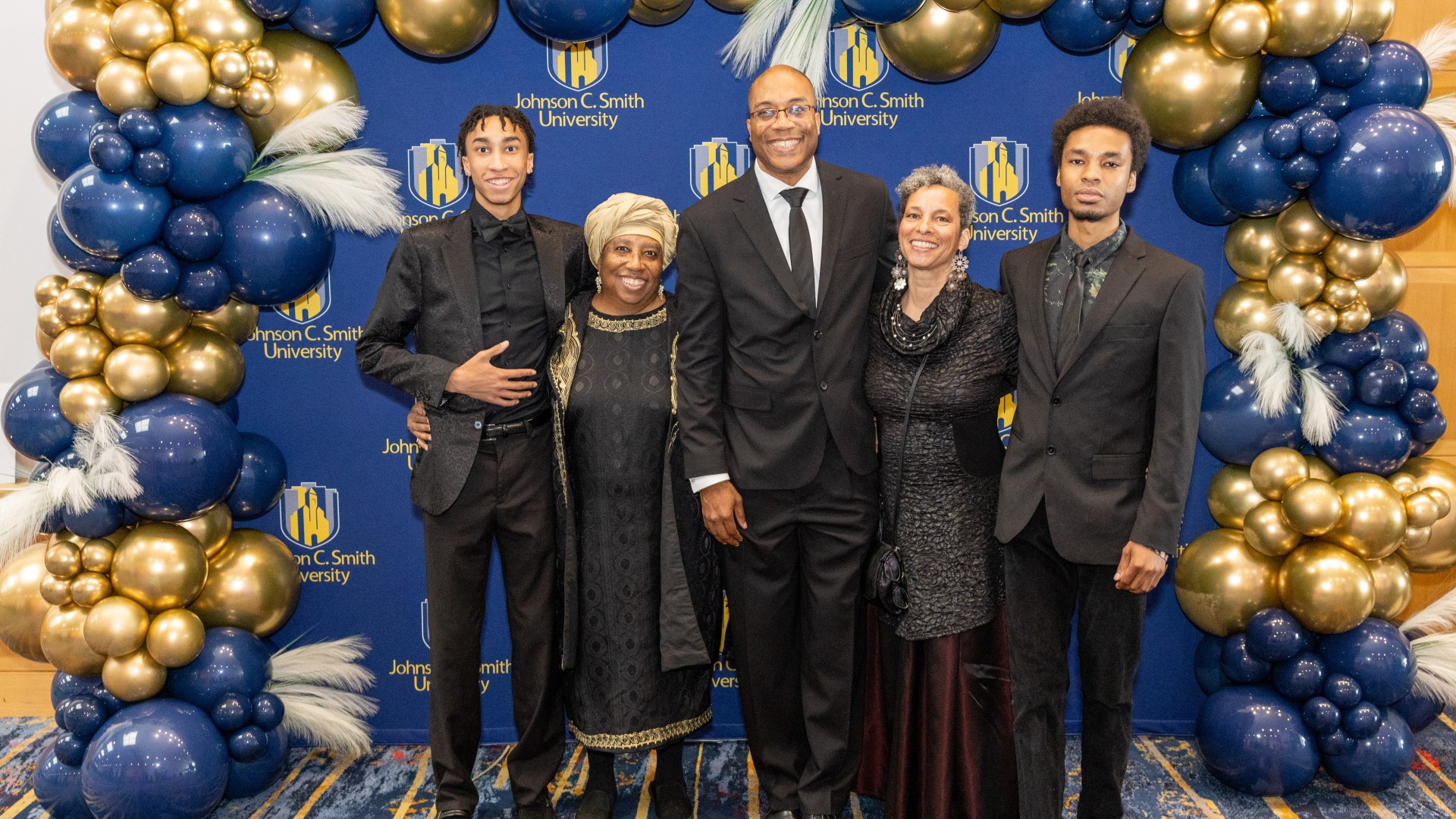 Charles Thomas and family a the step and repeat