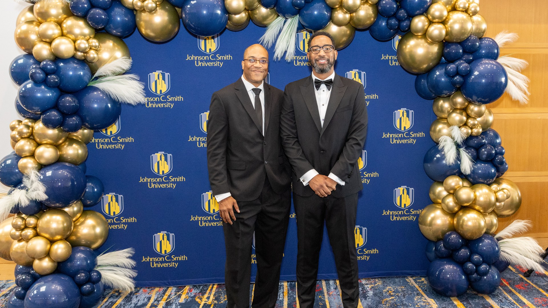 Lex Bibbs and Charles Thomas at the step and repeat