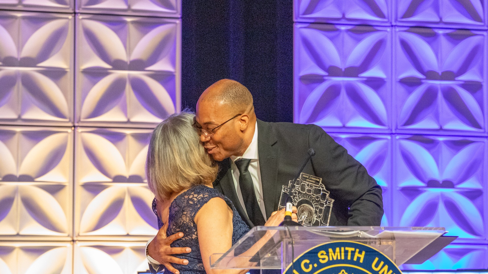 Charles Thomas accepting award from Vi Lyles